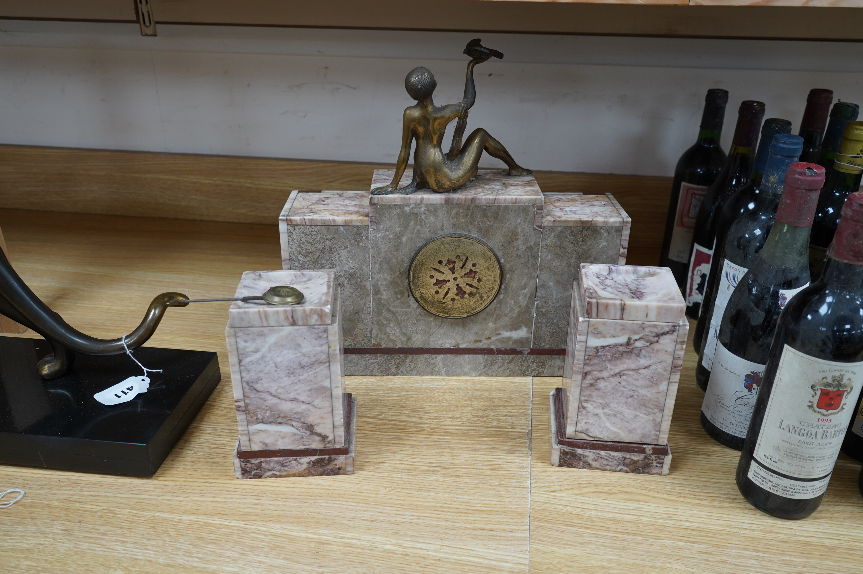 A French Art Deco brass mounted marble clock garniture with figural surmount, clock 38cm wide. Condition - good, unknown if clock working